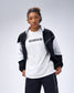 Model wearing the black RUDIS Movement Podium Jacket open over an Iron Sharpens Iron T-shirt with matching black pants.