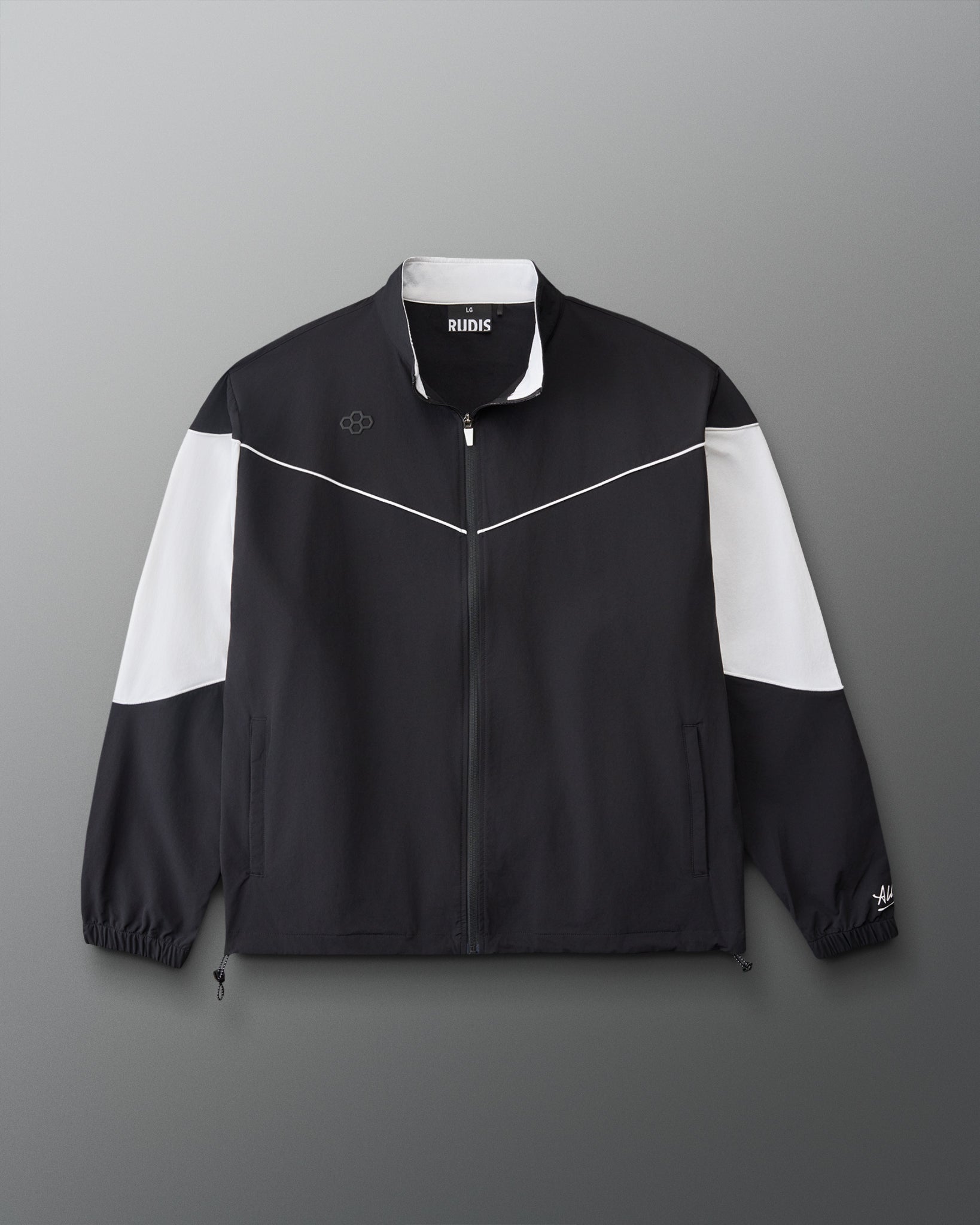 Front view of the RUDIS Full Zip Movement Podium Jacket in black with white sleeve panels, full-zip closure, and RUDIS logo.