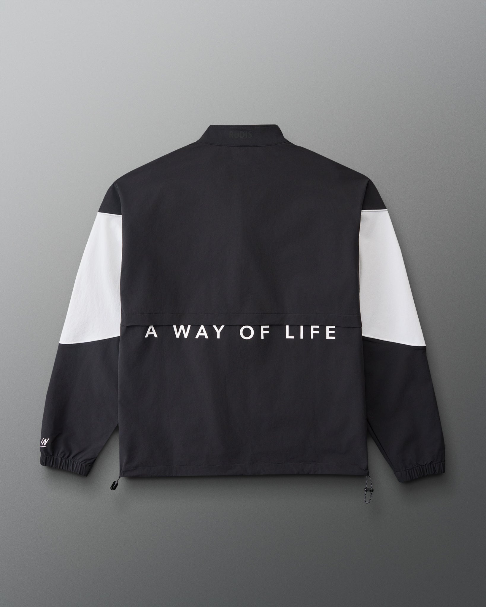 Back view of the RUDIS Full Zip Movement Podium Jacket in black and white featuring “A WAY OF LIFE” across the back.