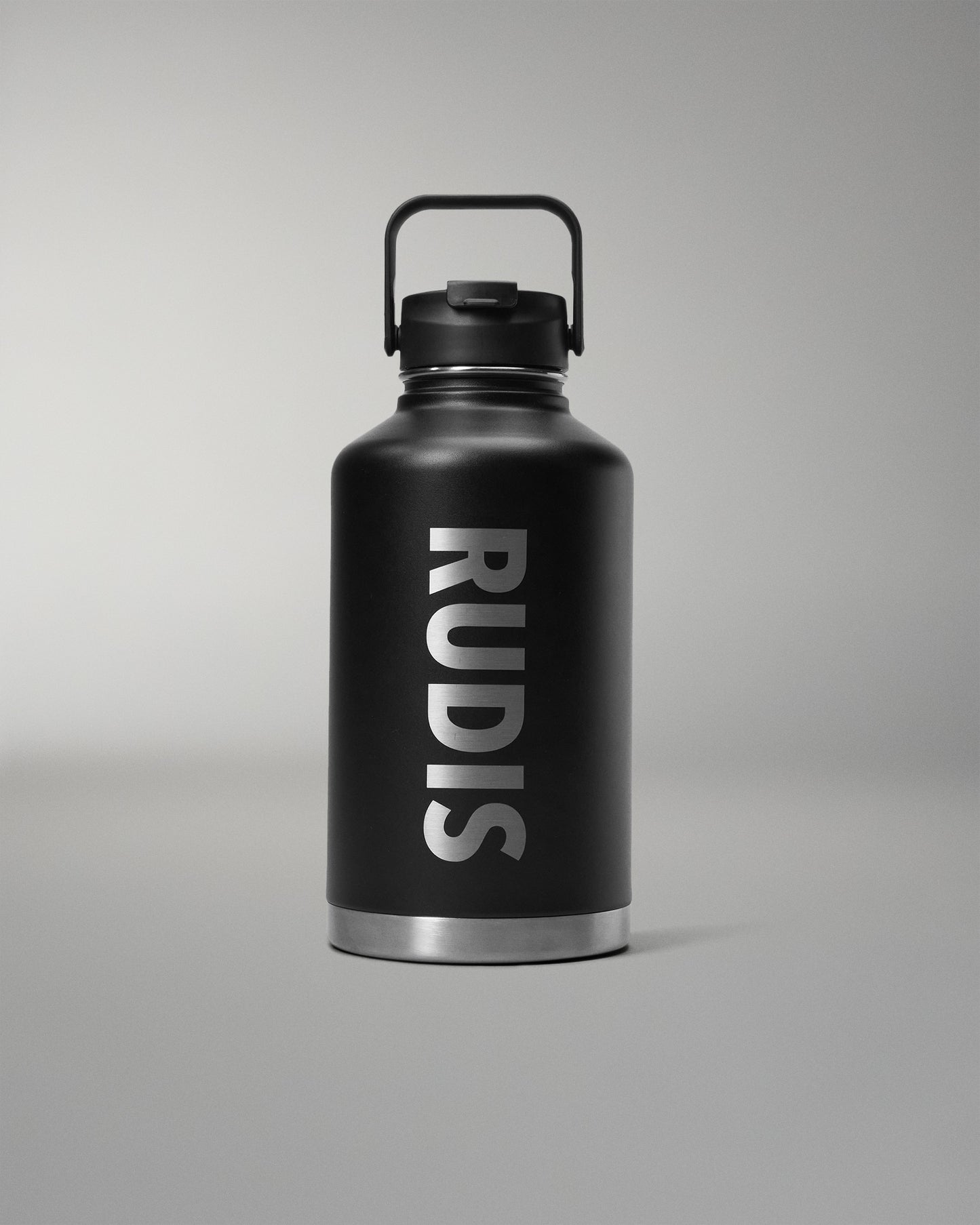 Black water bottle with 'RUDIS' branding on a gray background