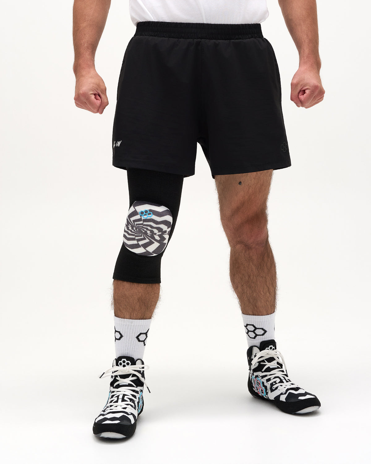 Front view of RUDIS Cushion Hypnosis Wrestling Knee Pad with black sleeve and graphic knee protection