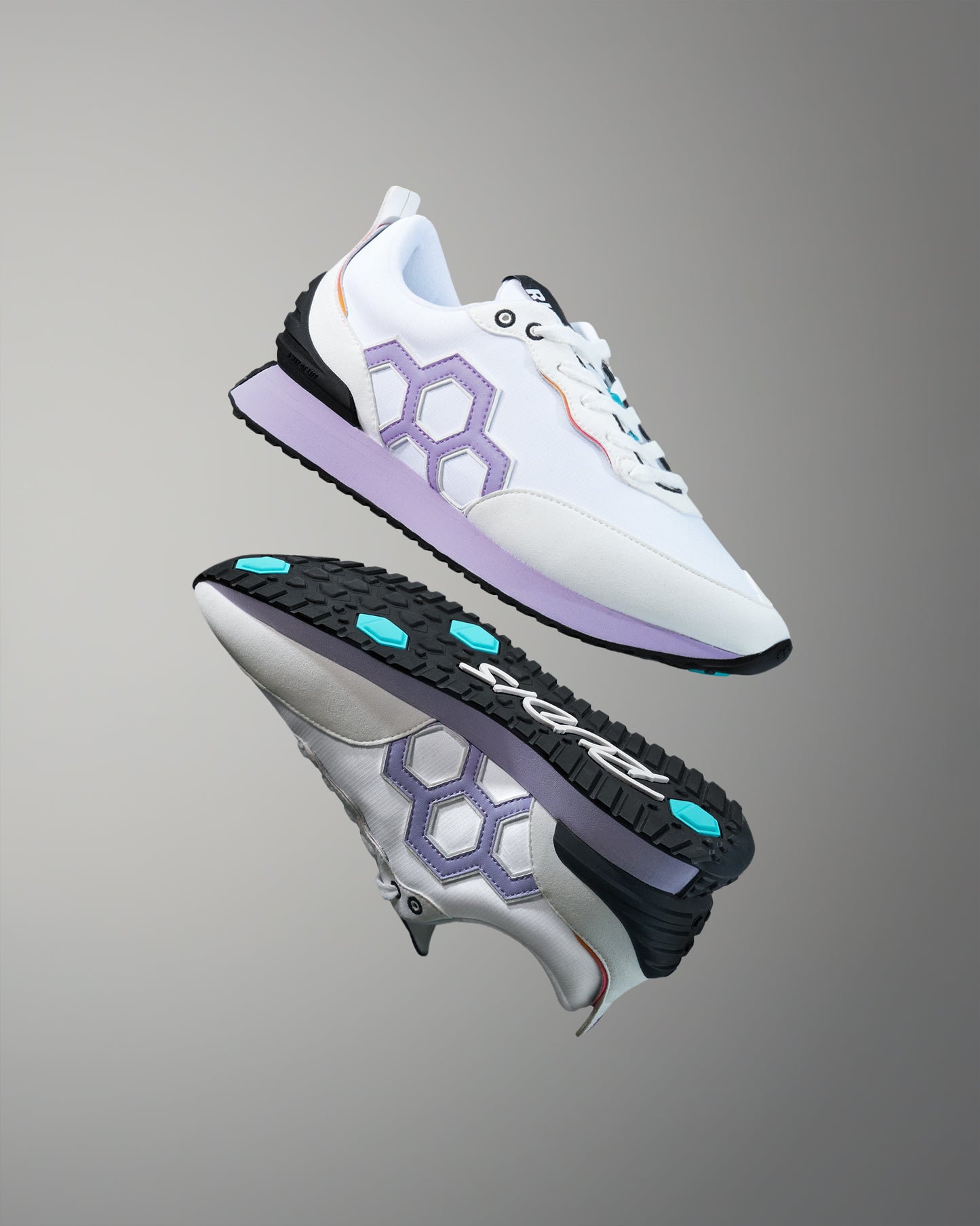 White and purple athletic shoes with a hexagonal design on a gray background
