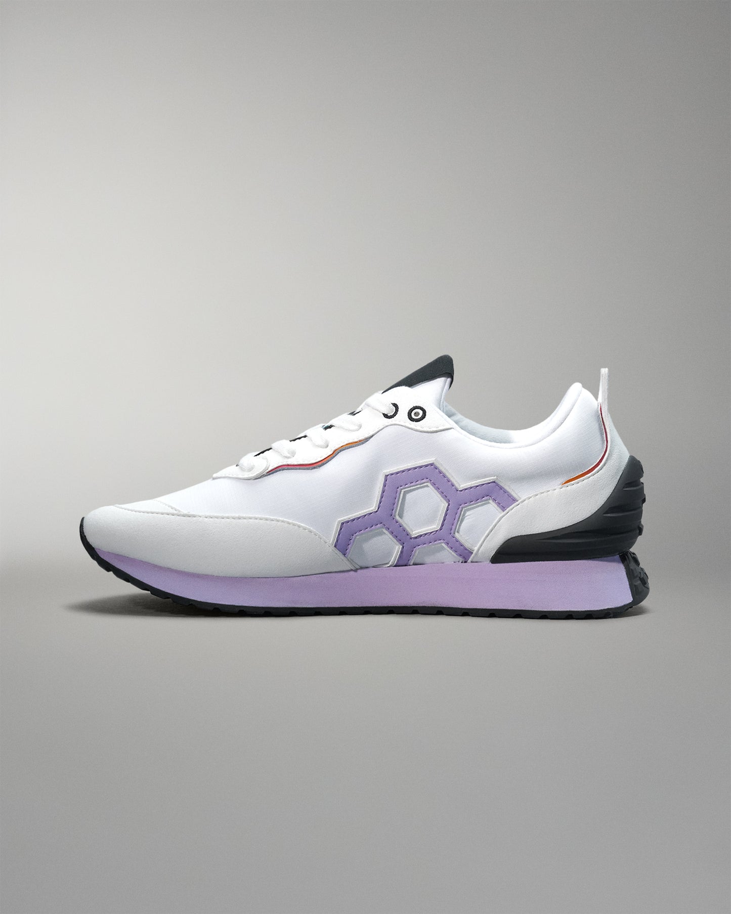 White sneaker with purple accents on a gray background