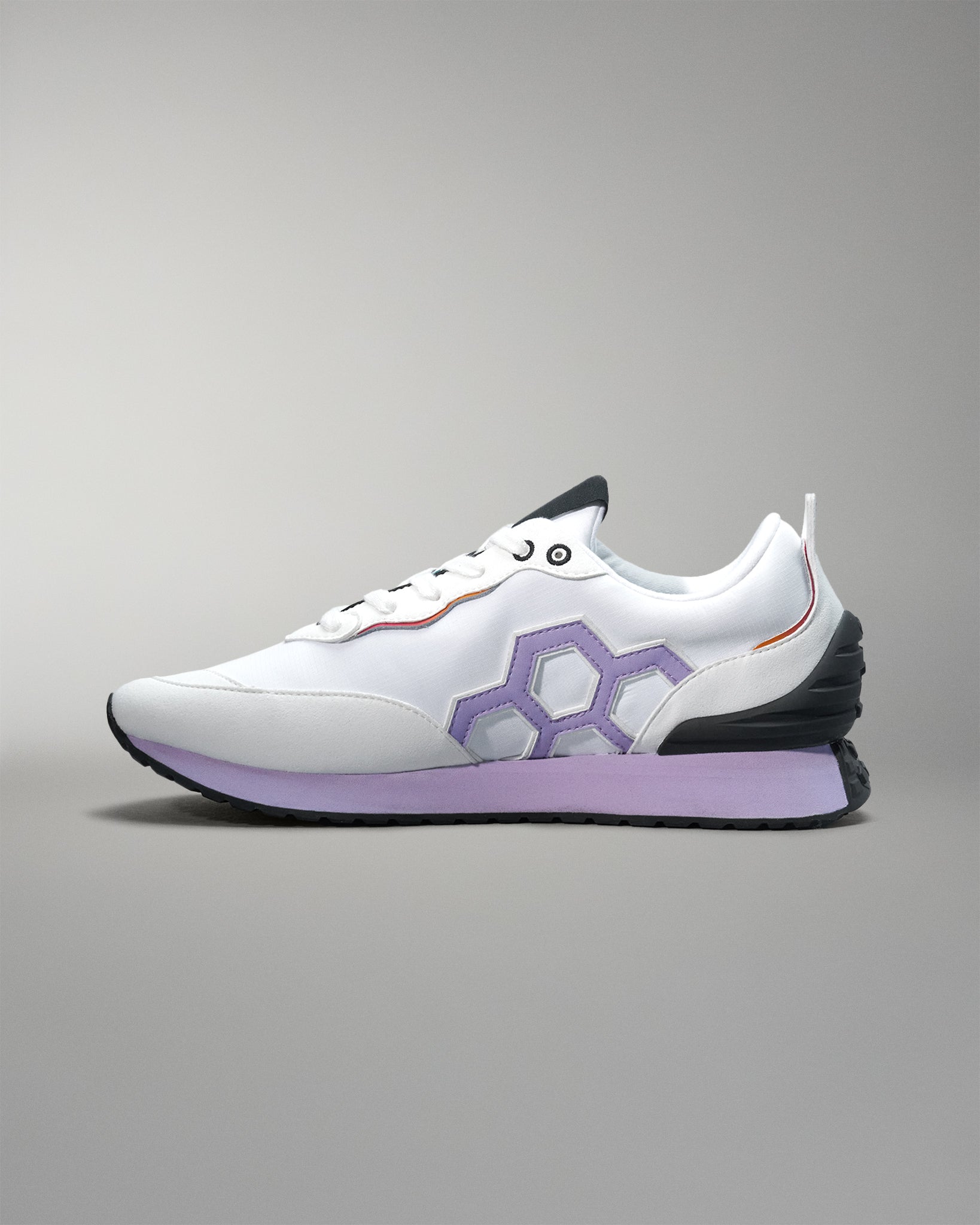 White sneaker with purple accents on a gray background