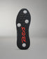 Close-up of a shoe sole with red branding on a gray background