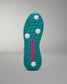 Teal shoe sole with pink logo on a gray background