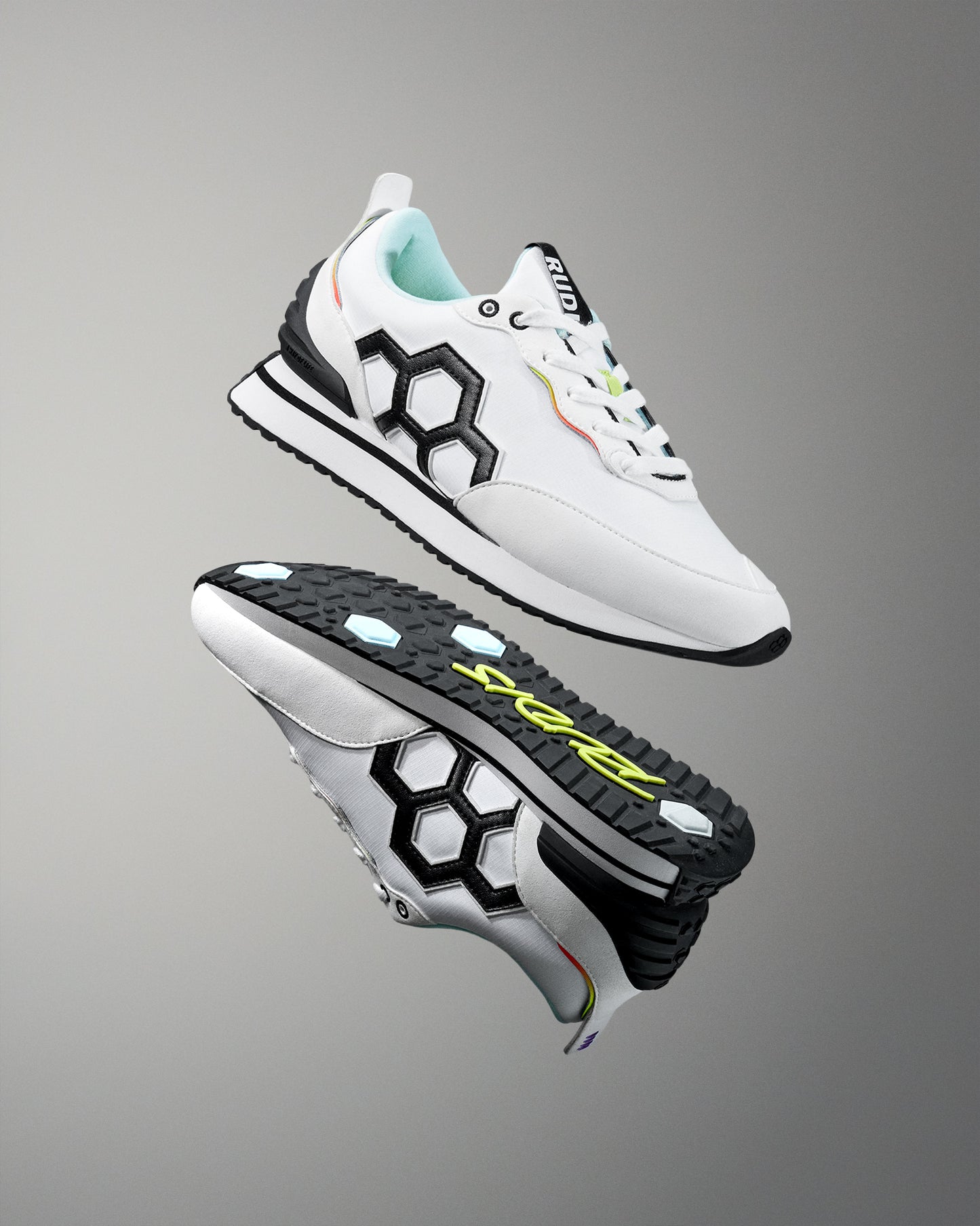 White sneakers with black and colorful accents on a gray background