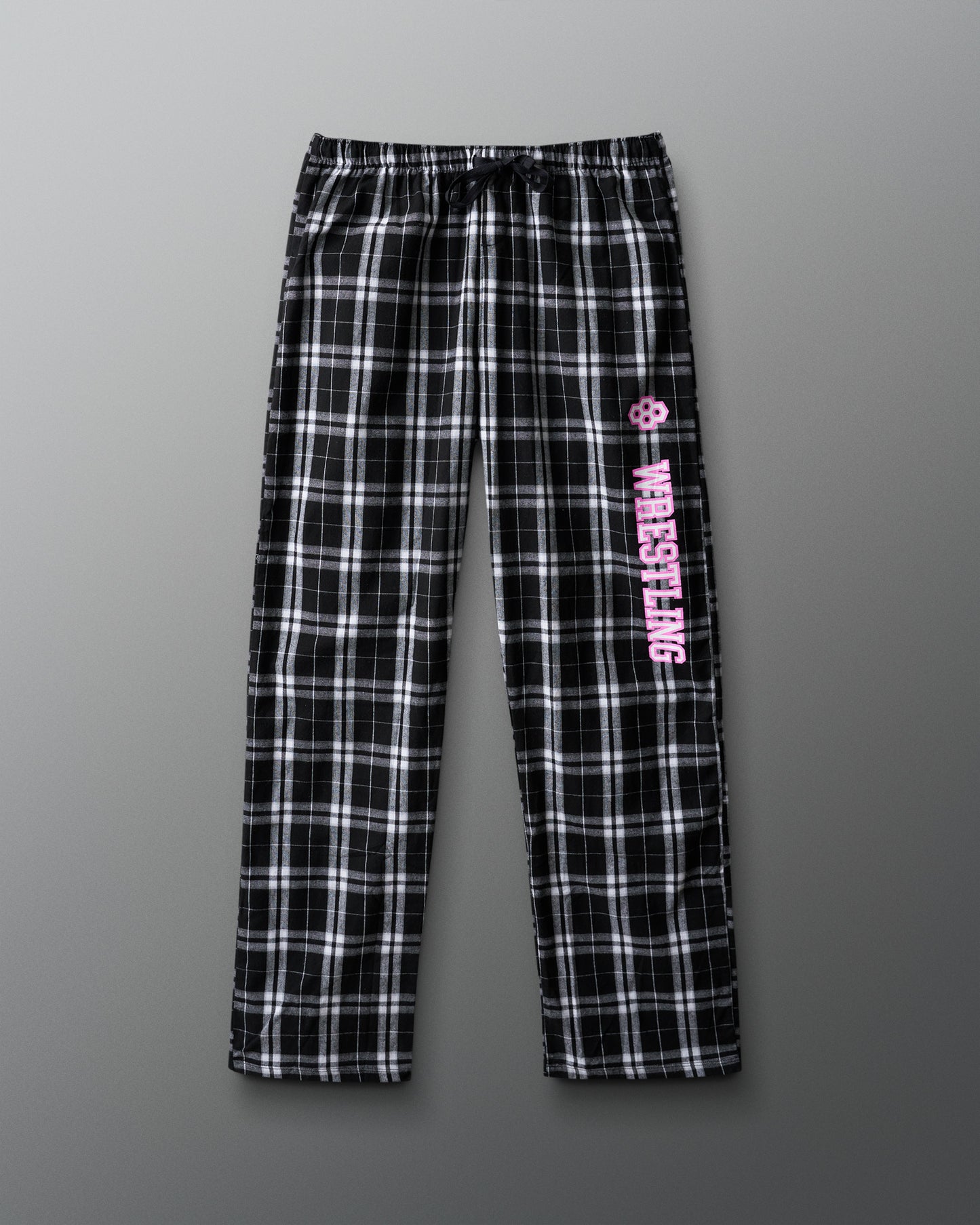 Black and white plaid pants with pink text on a gray background