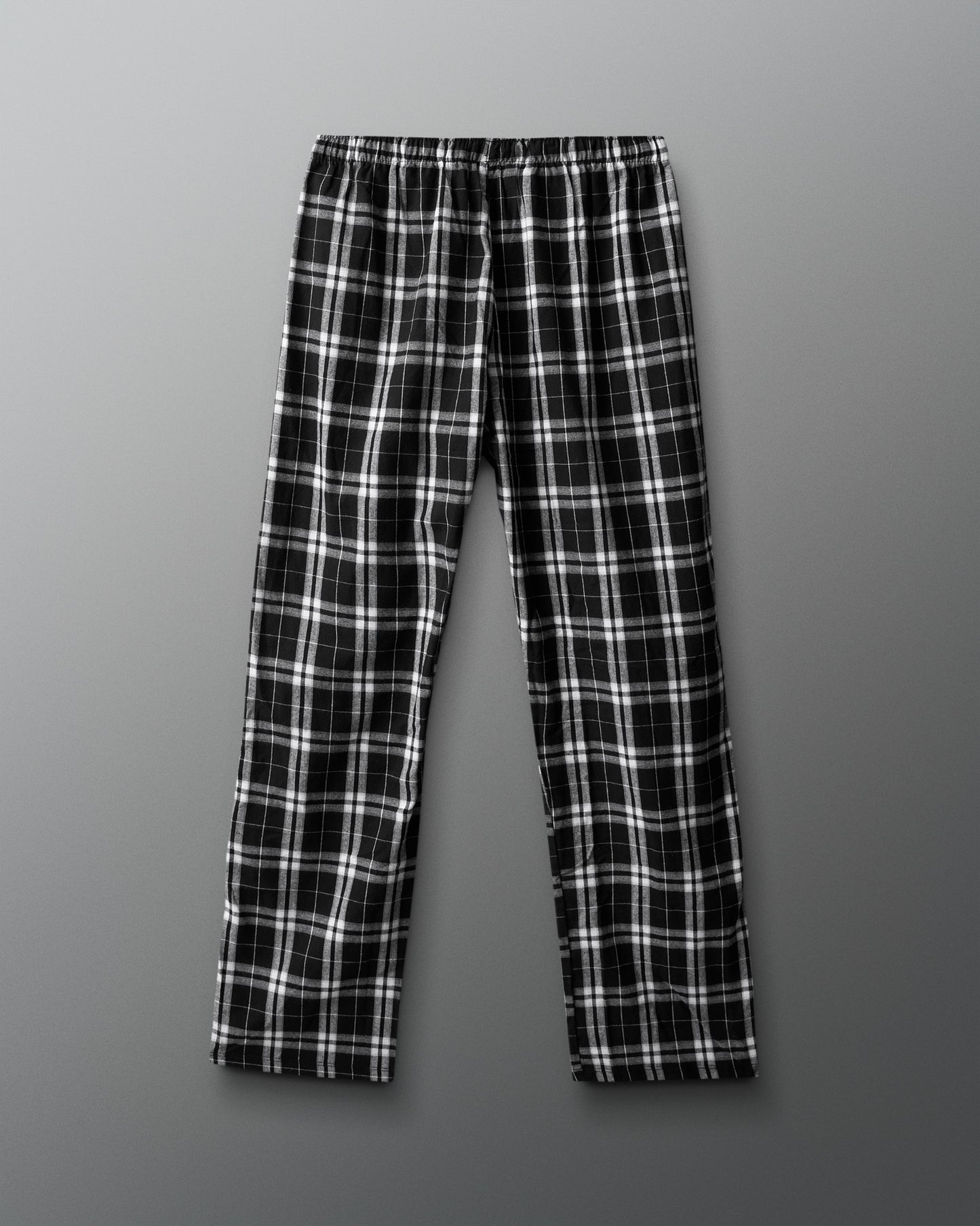 Black and white plaid pants on a gray background