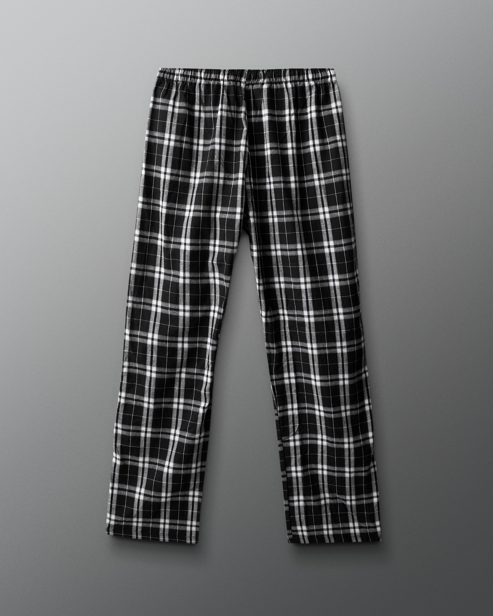 Black and white plaid pants on a gray background
