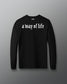 Black long-sleeve shirt with 'a way of life' text on a gray background