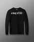 Black long-sleeve shirt with 'a way of life' text on a gray background