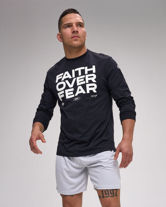 Man wearing a black long-sleeve shirt with 'Faith Over Fear' text on a gray background