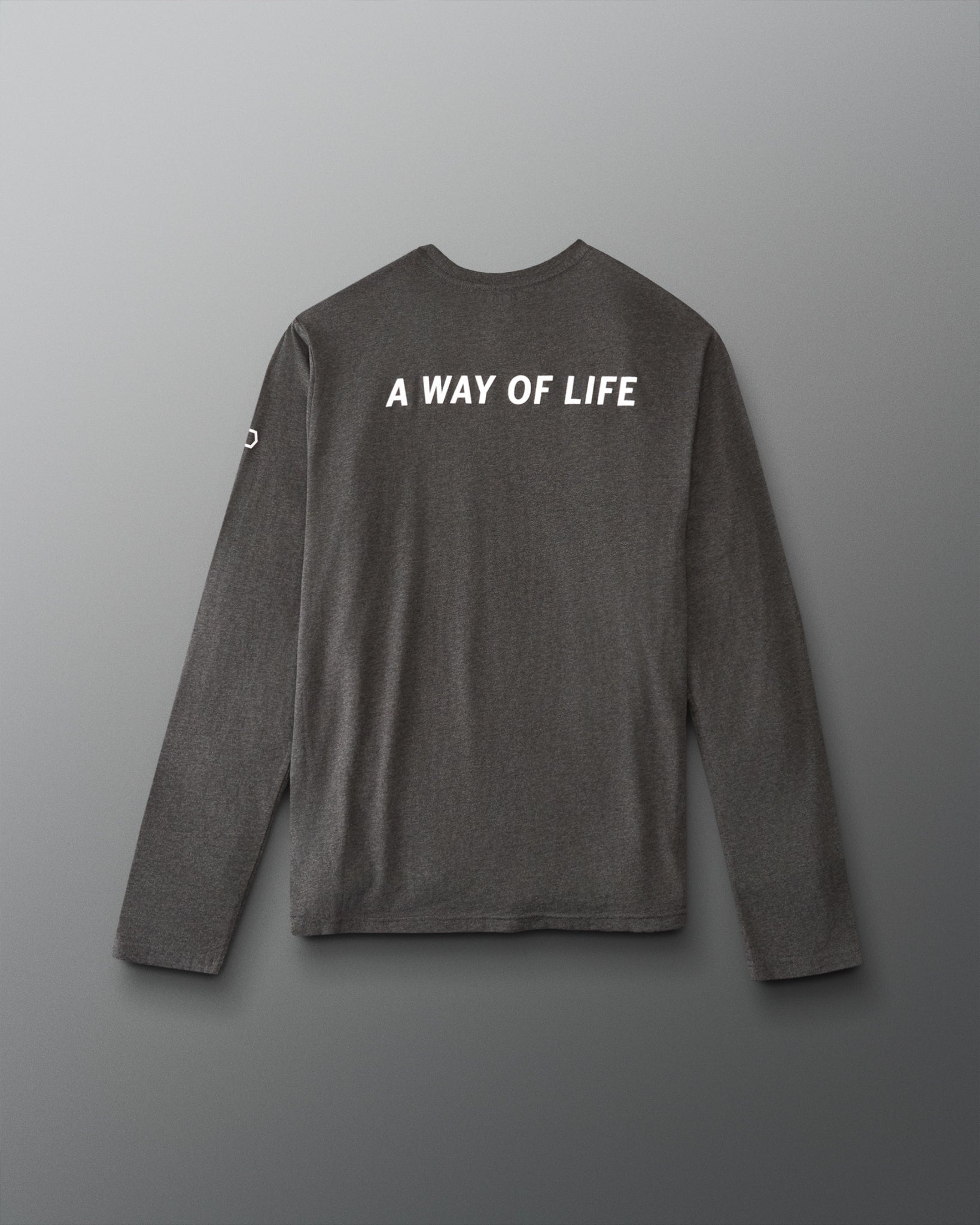 A dark gray long-sleeve t-shirt with 'A WAY OF LIFE' printed in white capital letters across the upper back, displayed against a neutral gray background.