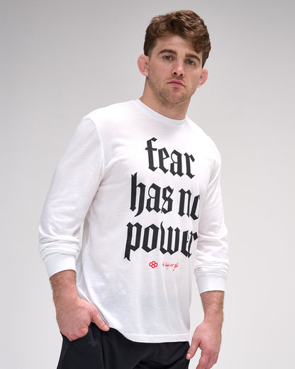Man wearing a white long-sleeve shirt with 'fear has no power' text on a gray background