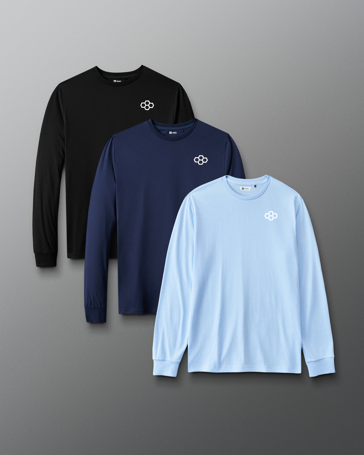 Front view of the RUDIS Essential Hex Elite Super Soft Long Sleeve 3-Pack in black, navy and light blue, each featuring a white RUDIS hex chest logo.