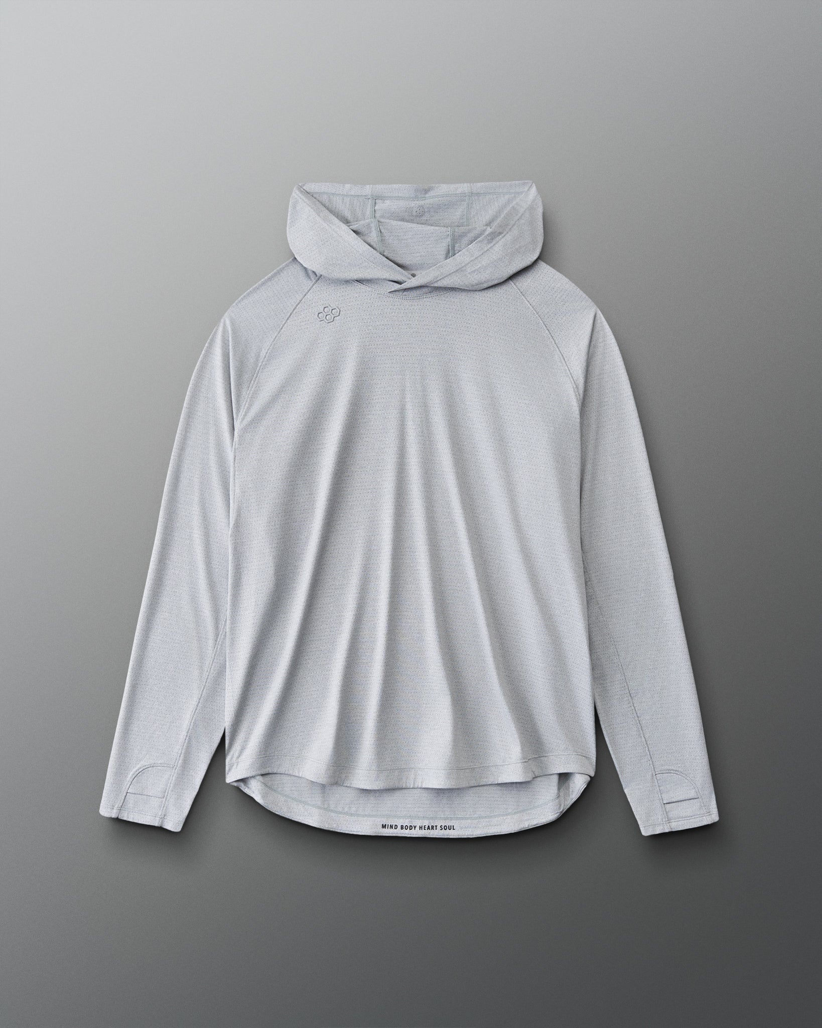 A light gray hooded long-sleeve athletic shirt with a high curved hem, displayed flat against a dark gray gradient background.
