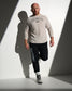 RUDIS Faith Over Fear Tech Thermal in Bone styled with black Gothic Wrestling Titan Heavyweight Joggers, featuring breathable performance fabric, gothic-inspired graphics, and a versatile athletic fit.