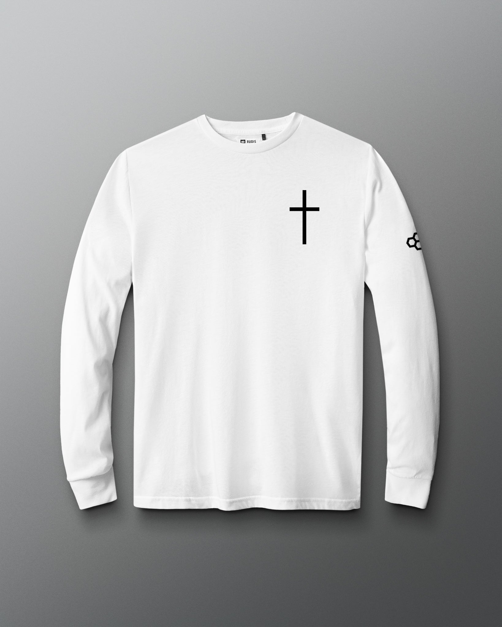 A white long-sleeve crewneck t-shirt with a black cross printed on the left chest and a small black logo on the right sleeve, displayed against a dark gray gradient background.