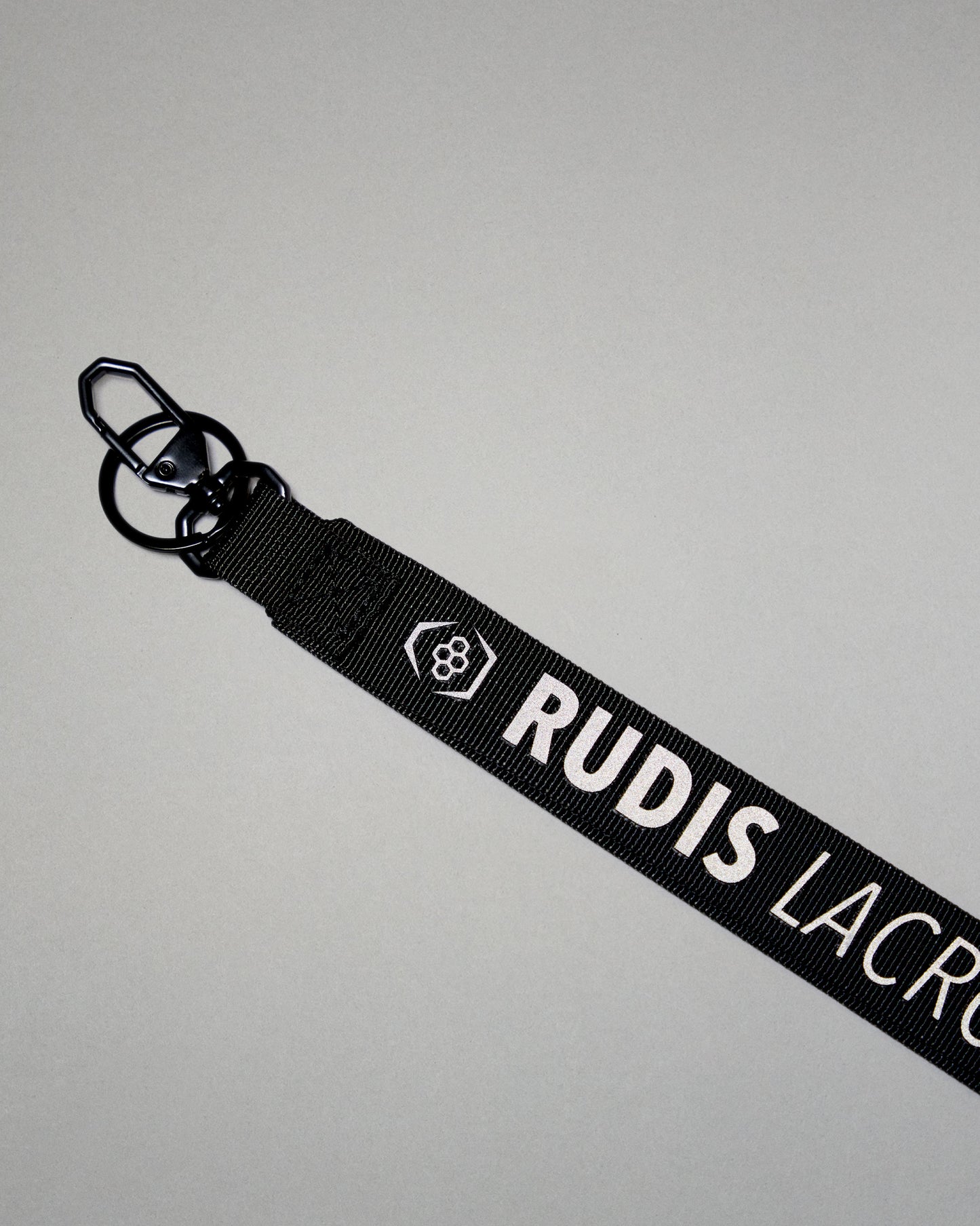 Black RUDIS Lacrosse lanyard with woven logo, durable fabric strap, key ring, and metal clasp.