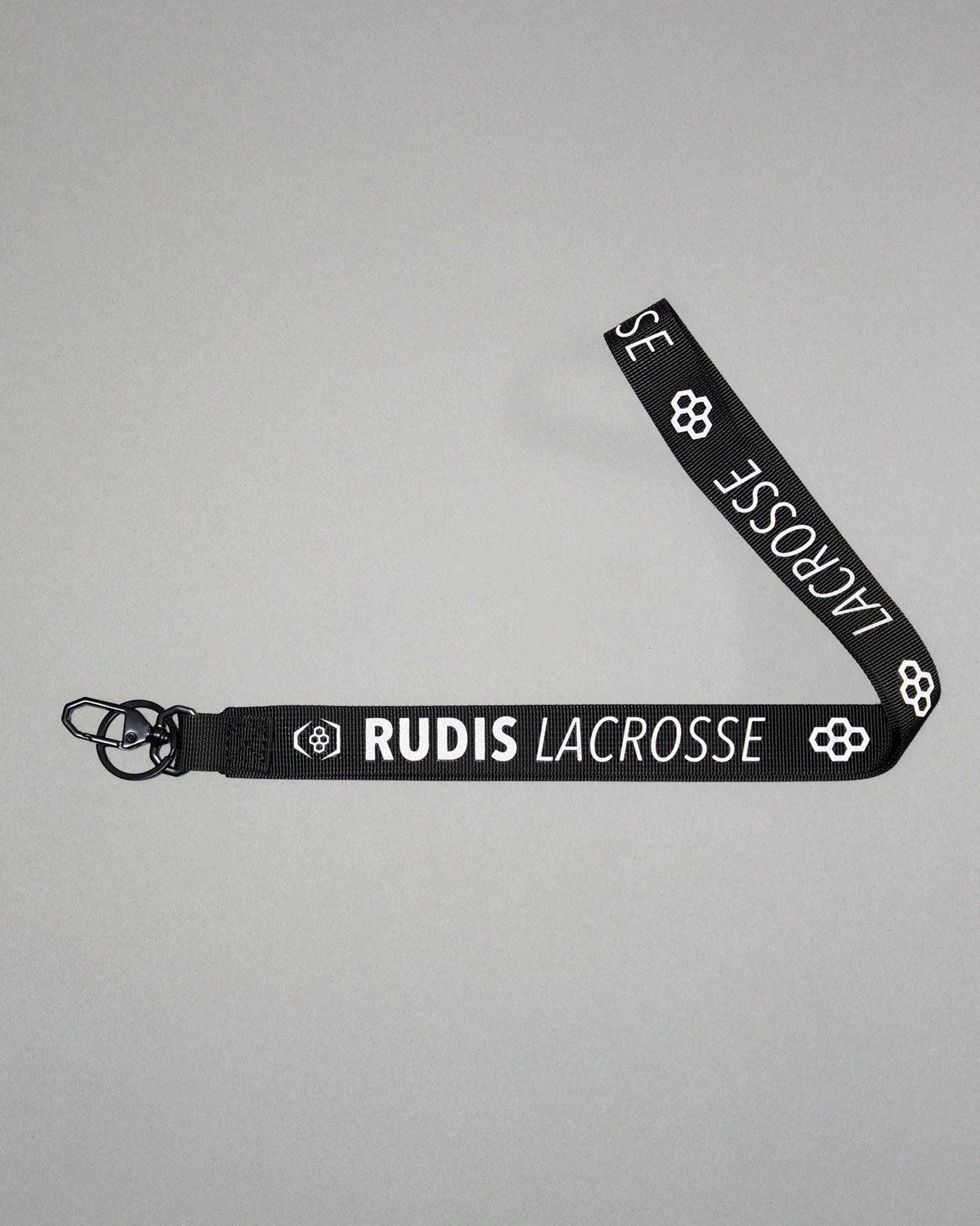 Black RUDIS Lacrosse lanyard with woven logo, durable fabric strap, key ring, and metal clasp.