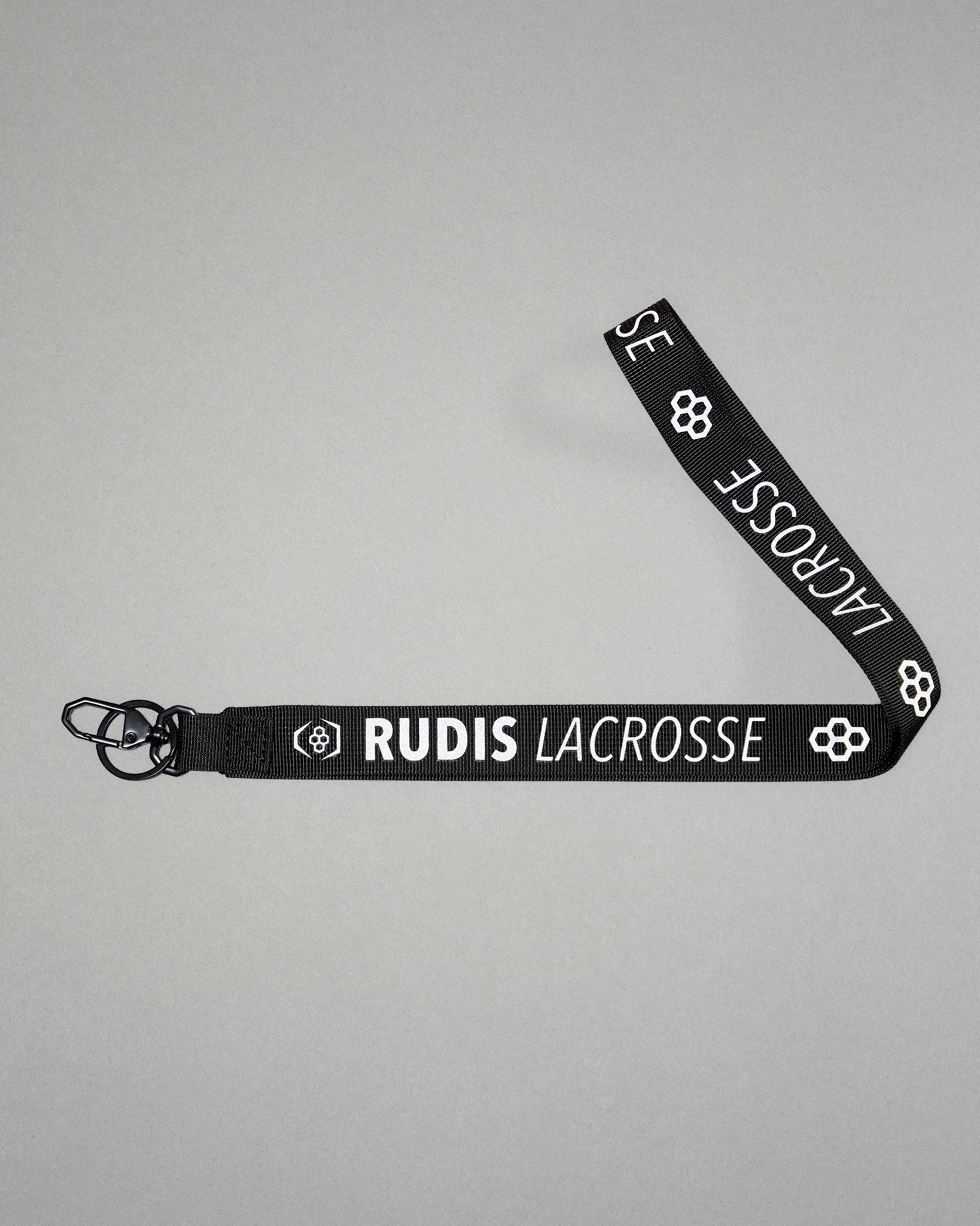 Black RUDIS Lacrosse lanyard with woven logo, durable fabric strap, key ring, and metal clasp.