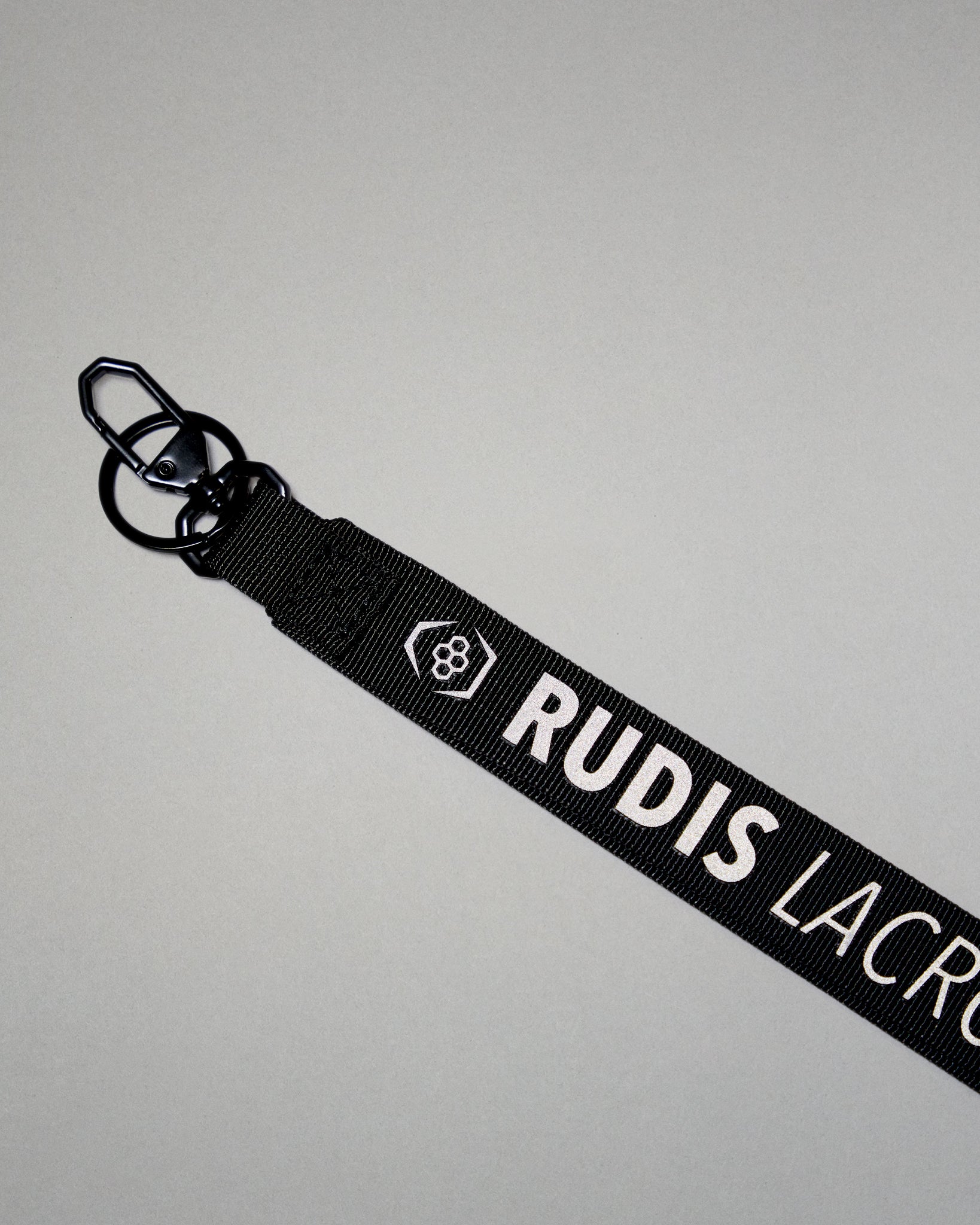 Black RUDIS Lacrosse lanyard with woven logo, durable fabric strap, key ring, and metal clasp.