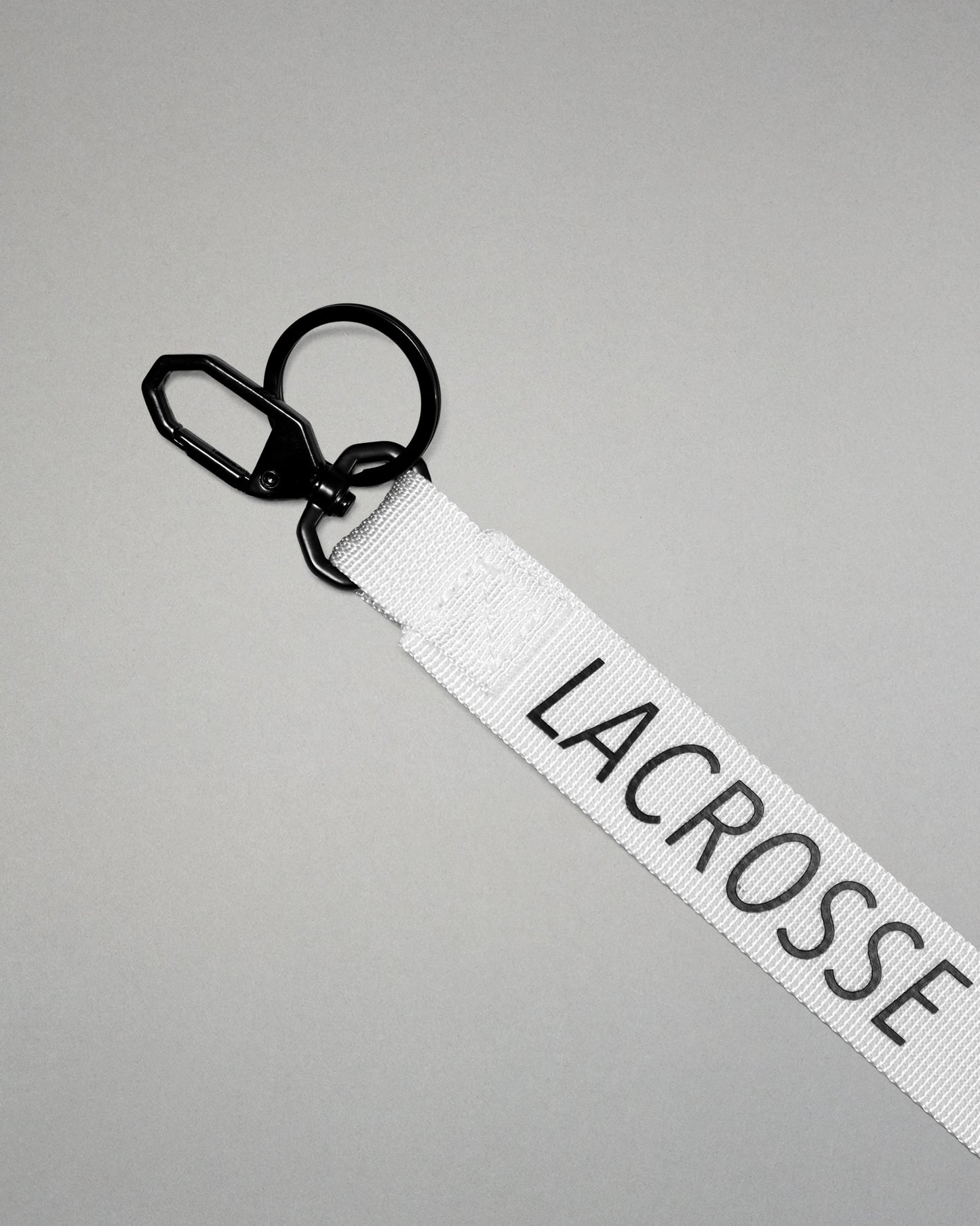 white RUDIS Lacrosse lanyard with woven logo, durable fabric strap, key ring, and metal clasp.