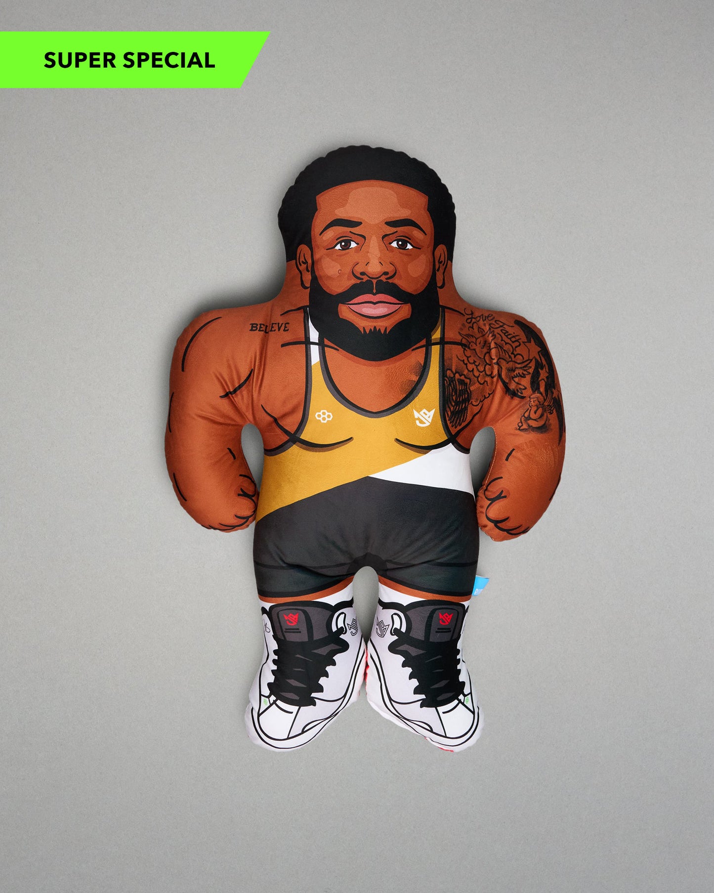 Pillow of a man with tattoos and a wrestling singlet on a gray background