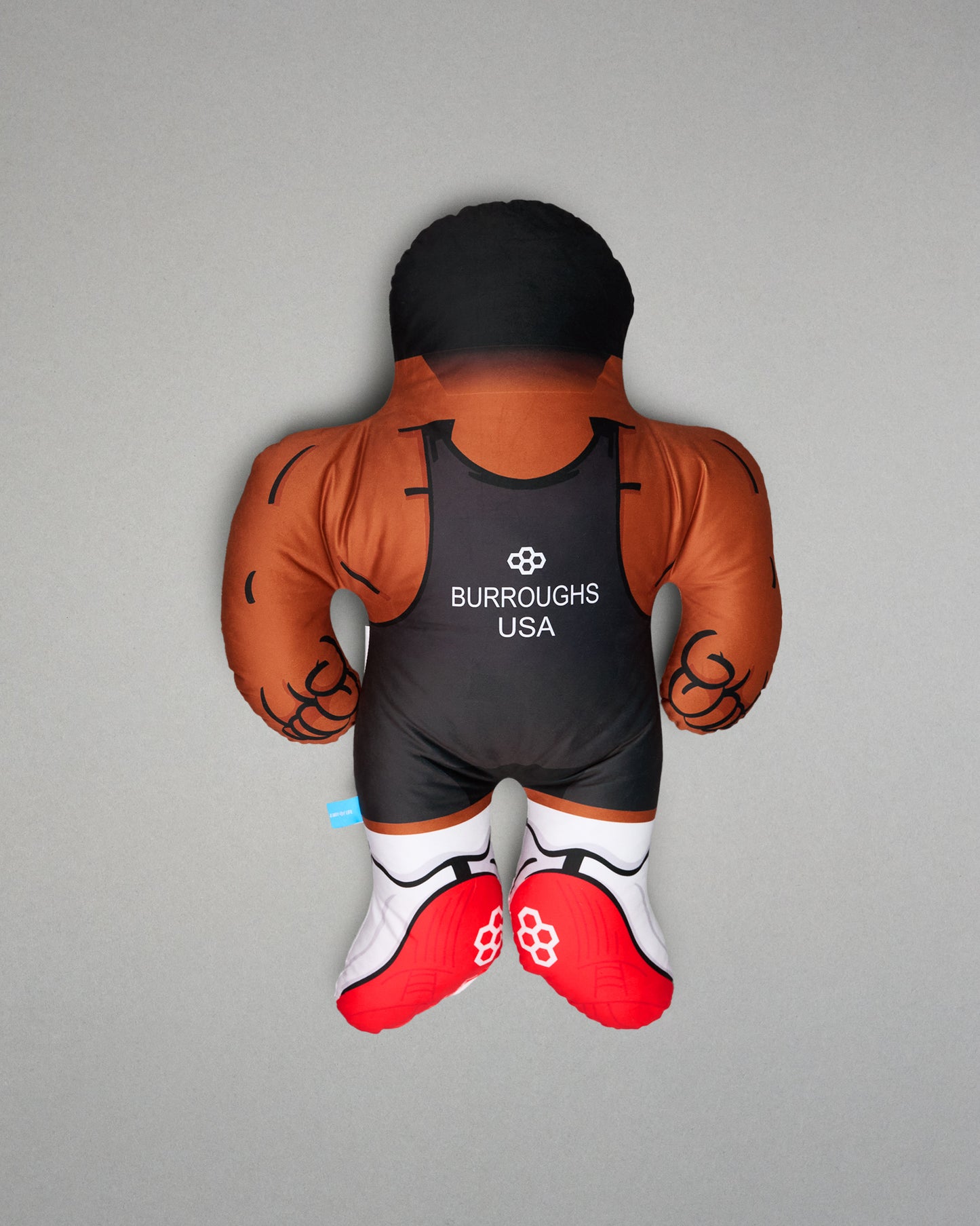 PIllow resembling a wrestler with 'Burroughs USA' branding on a gray background
