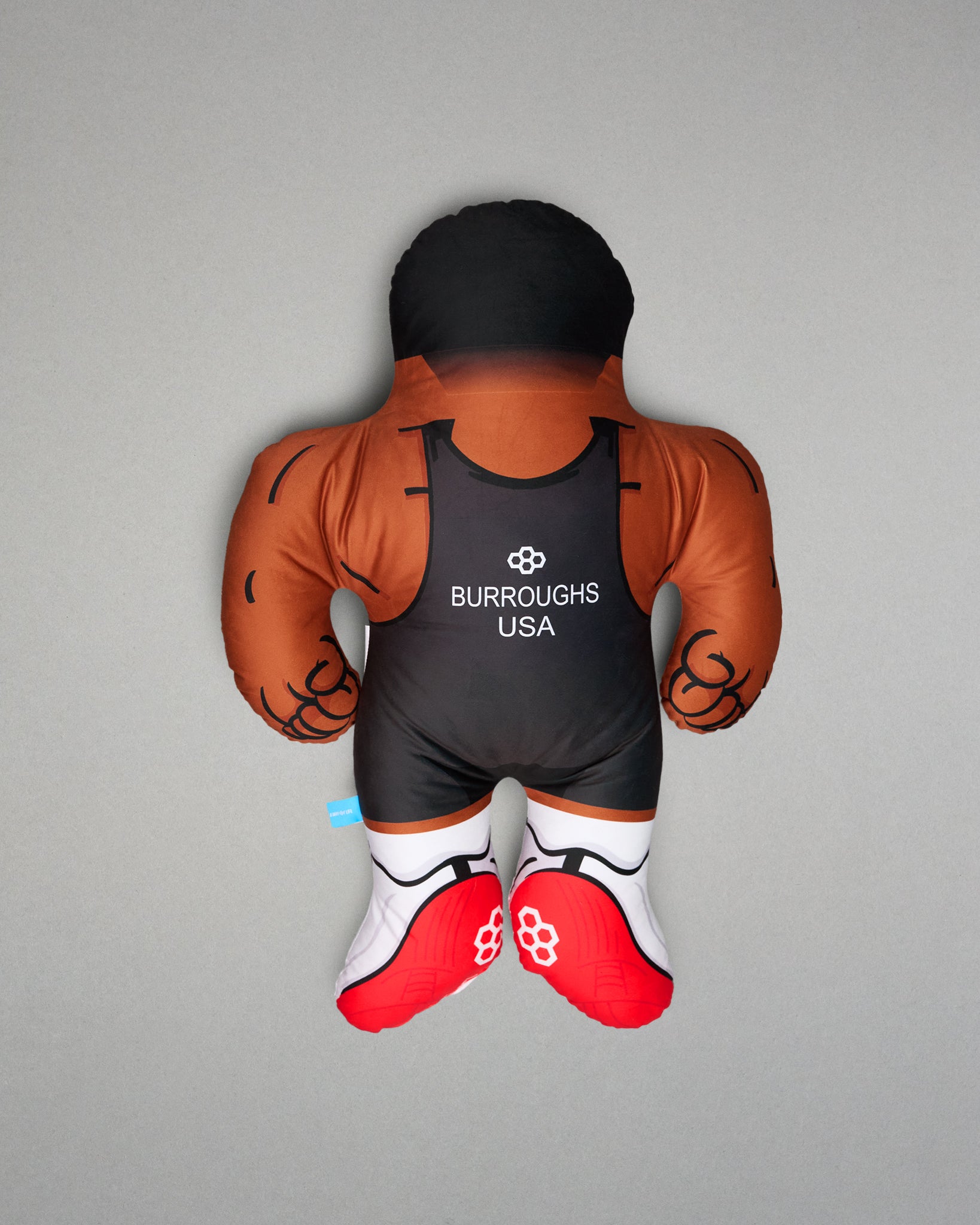 PIllow resembling a wrestler with 'Burroughs USA' branding on a gray background