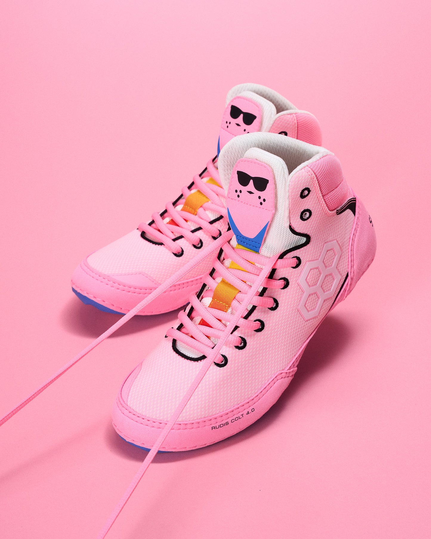 Pink wrestling shoes with energizer bunny character design on a pink background