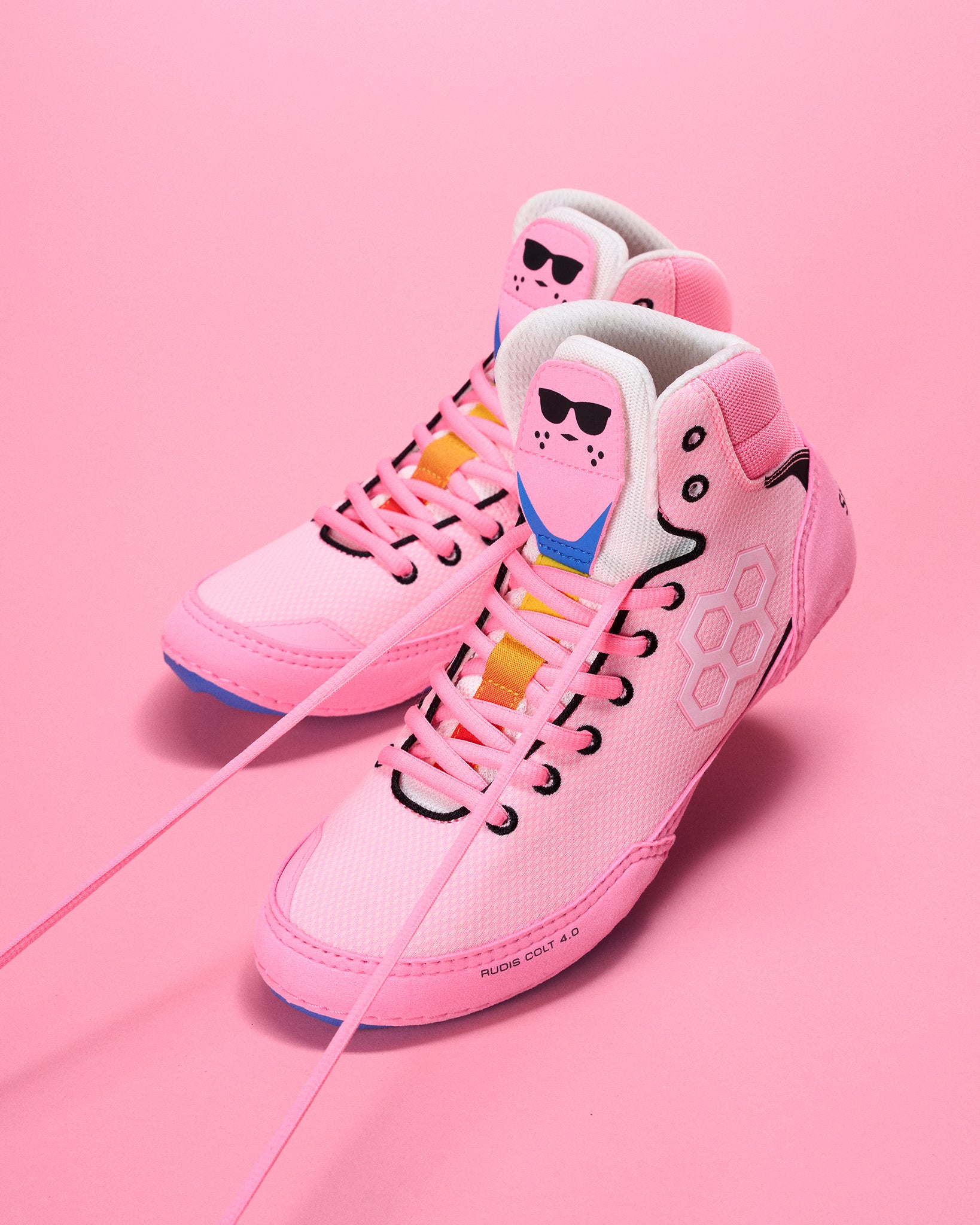 Pink wrestling shoes with energizer bunny character design on a pink background