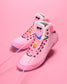 Pink wrestling shoes with energizer bunny character design on a pink background