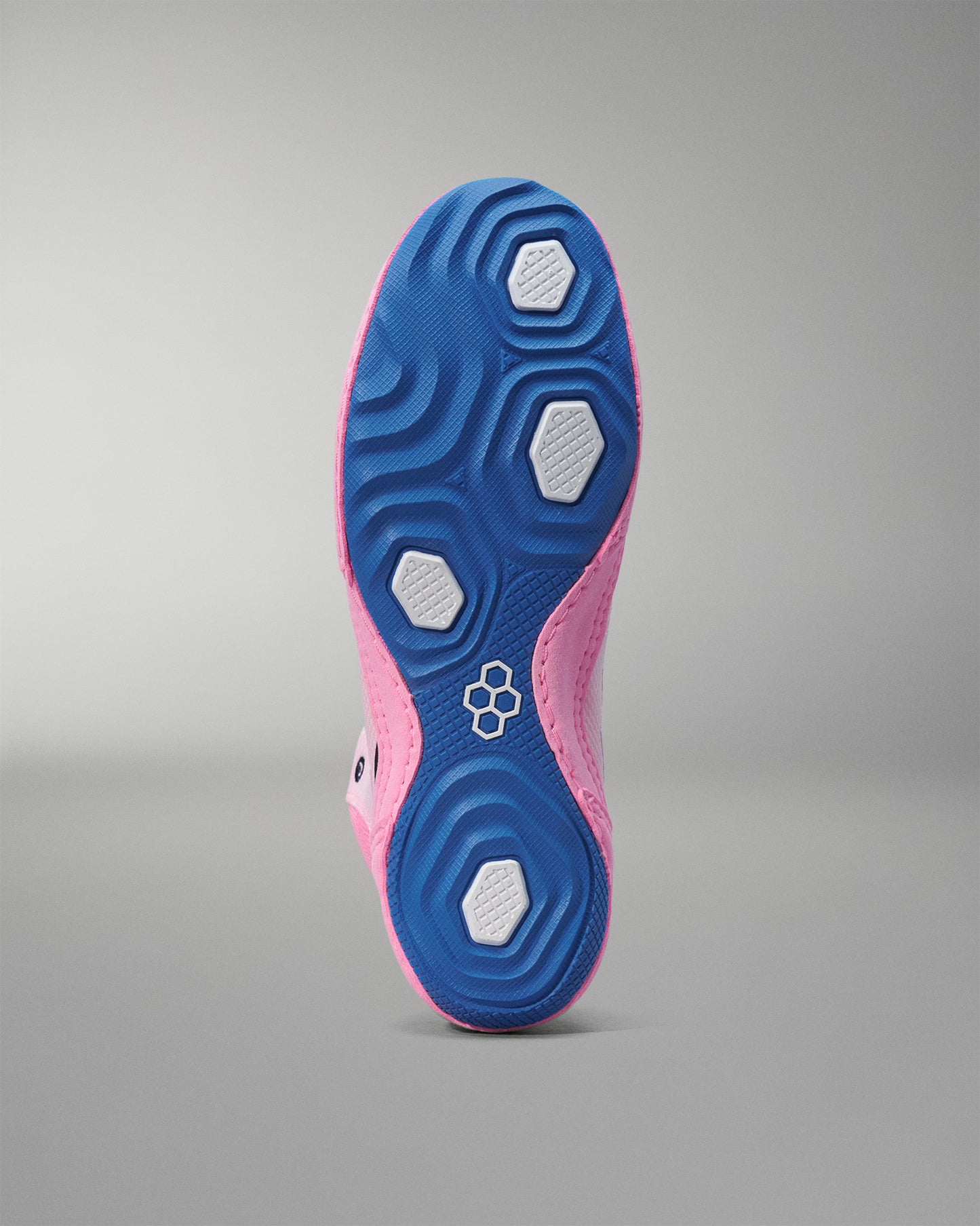 Pink and blue wrestling shoe sole on a gray background