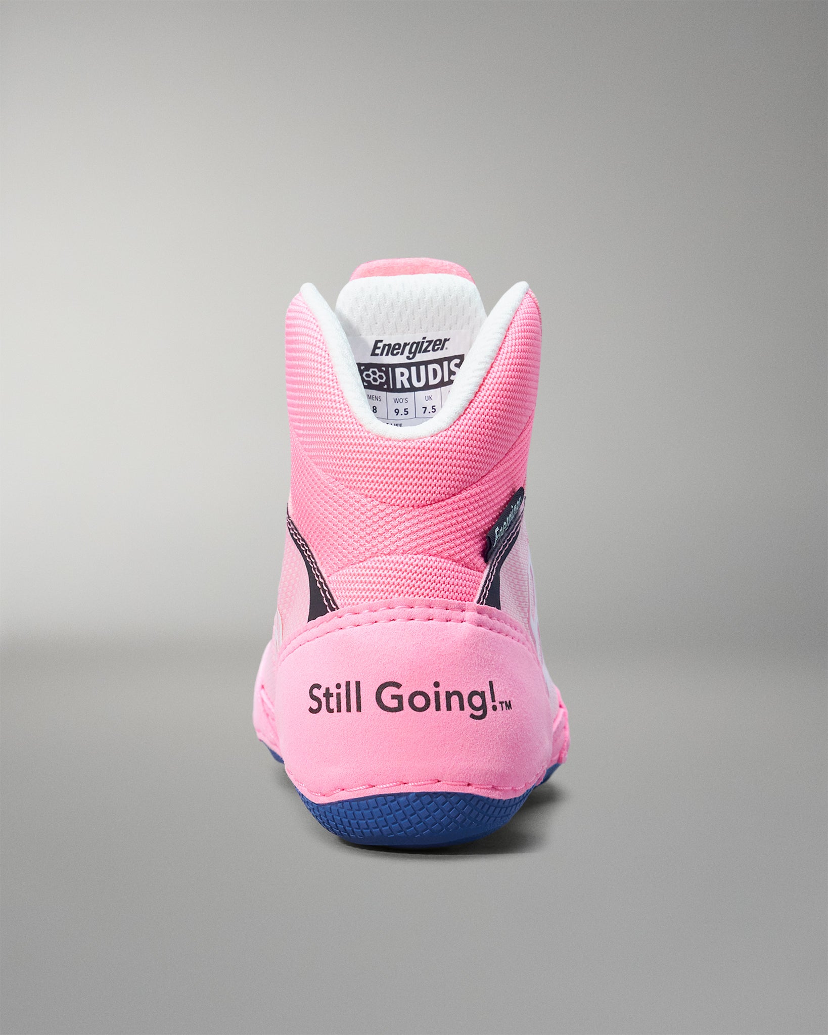 Pink wrestling shoe with 'Still Going!' text on a gray background