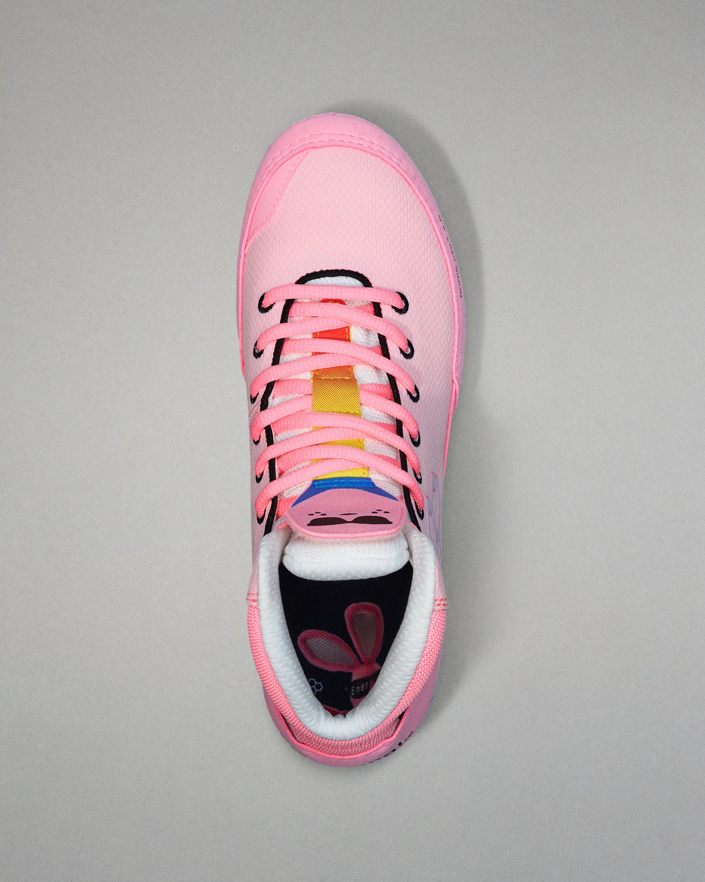 Pink wrestling shoe with colorful accents on a gray background