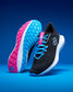 Black and pink running shoes with blue accents on a blue background