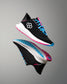 Black running shoes with blue and pink accents on a gray background