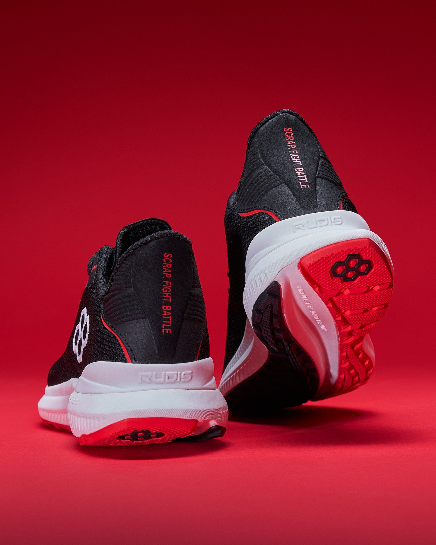 Black and red athletic shoes on a red background