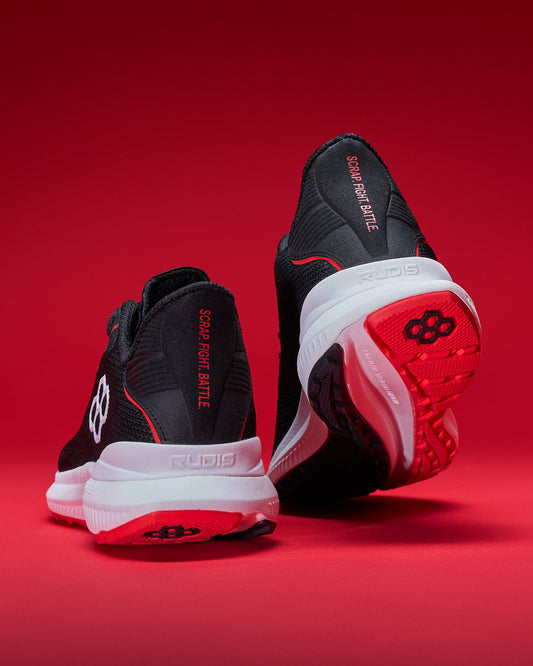Black and red athletic shoes on a red background