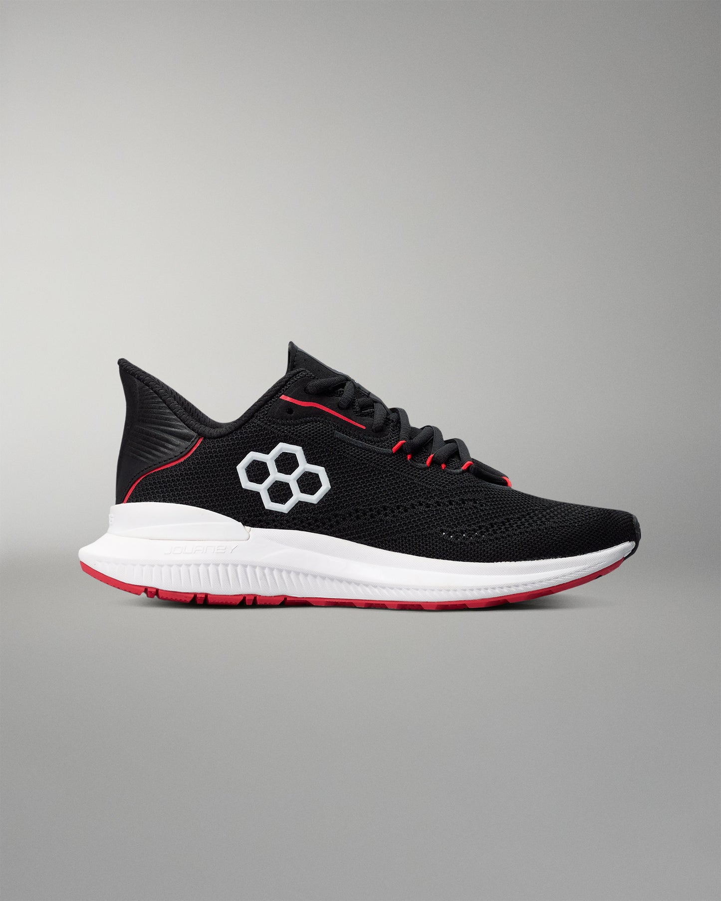 Black running shoe with red accents on a gray background