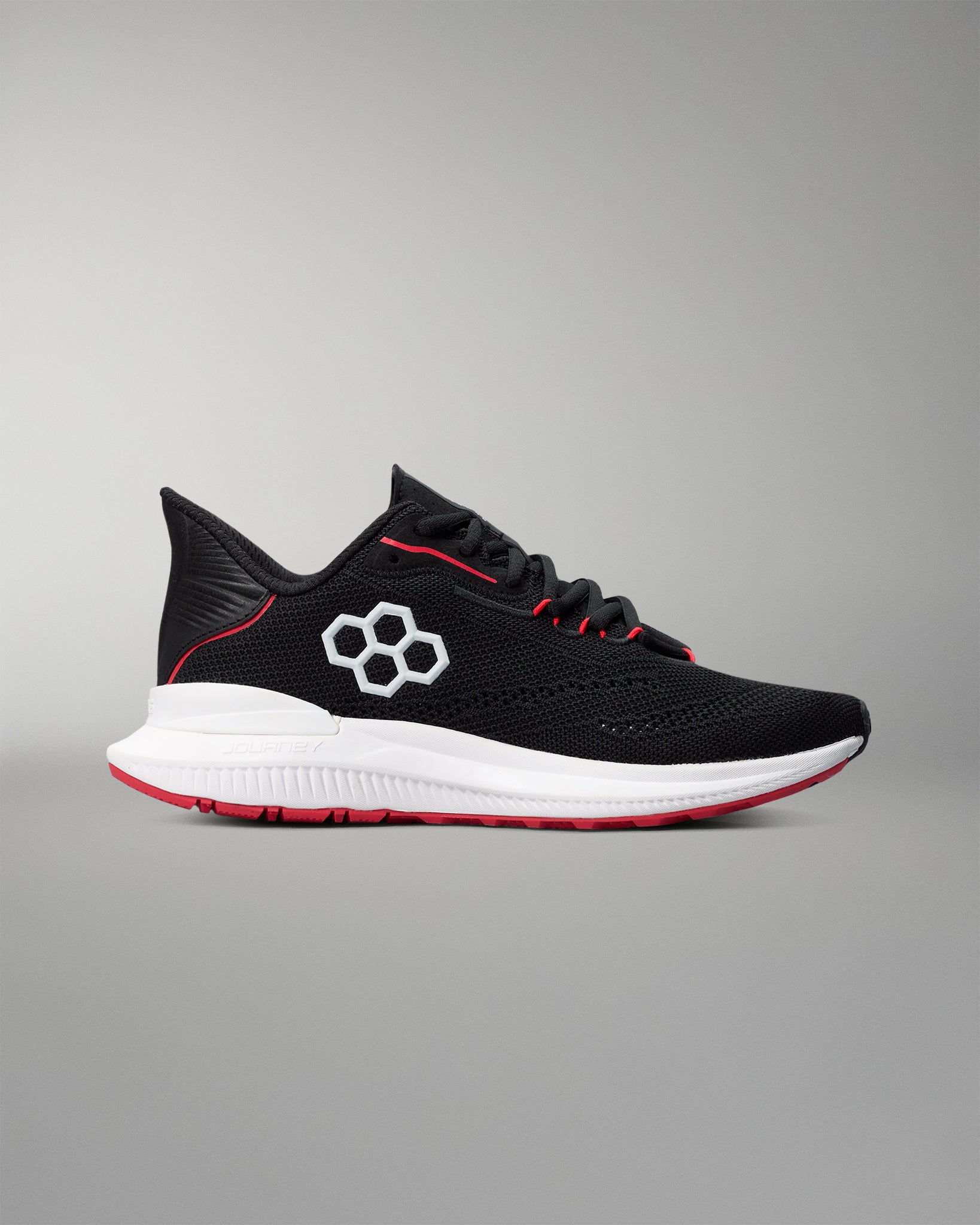 Black running shoe with red accents on a gray background