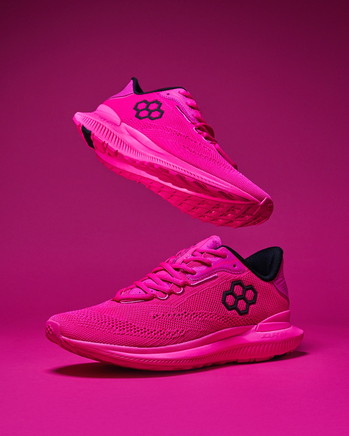 Pink running shoes with black logo on a pink background - wrestling training shoes