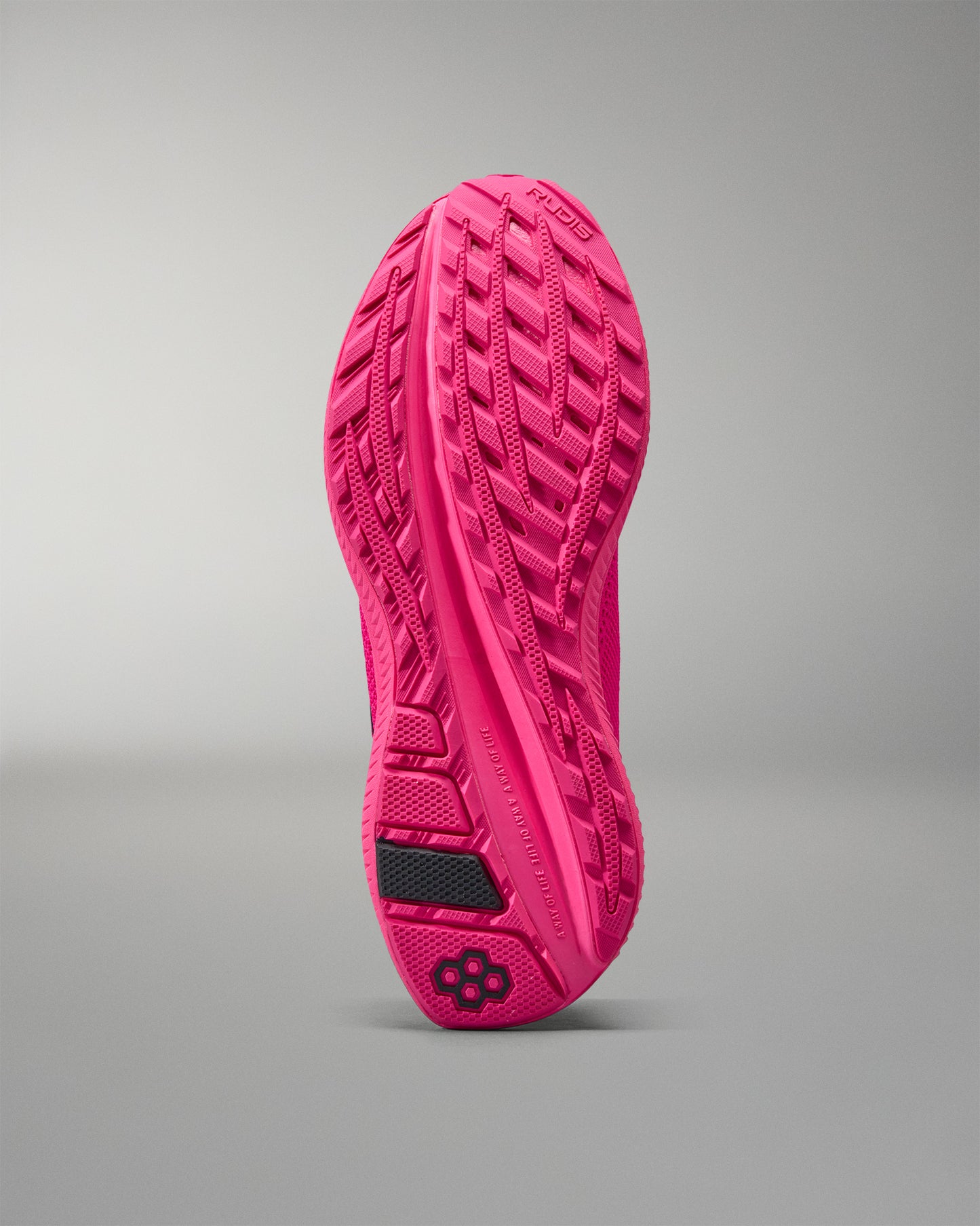 Pink athletic shoe sole on a gray background