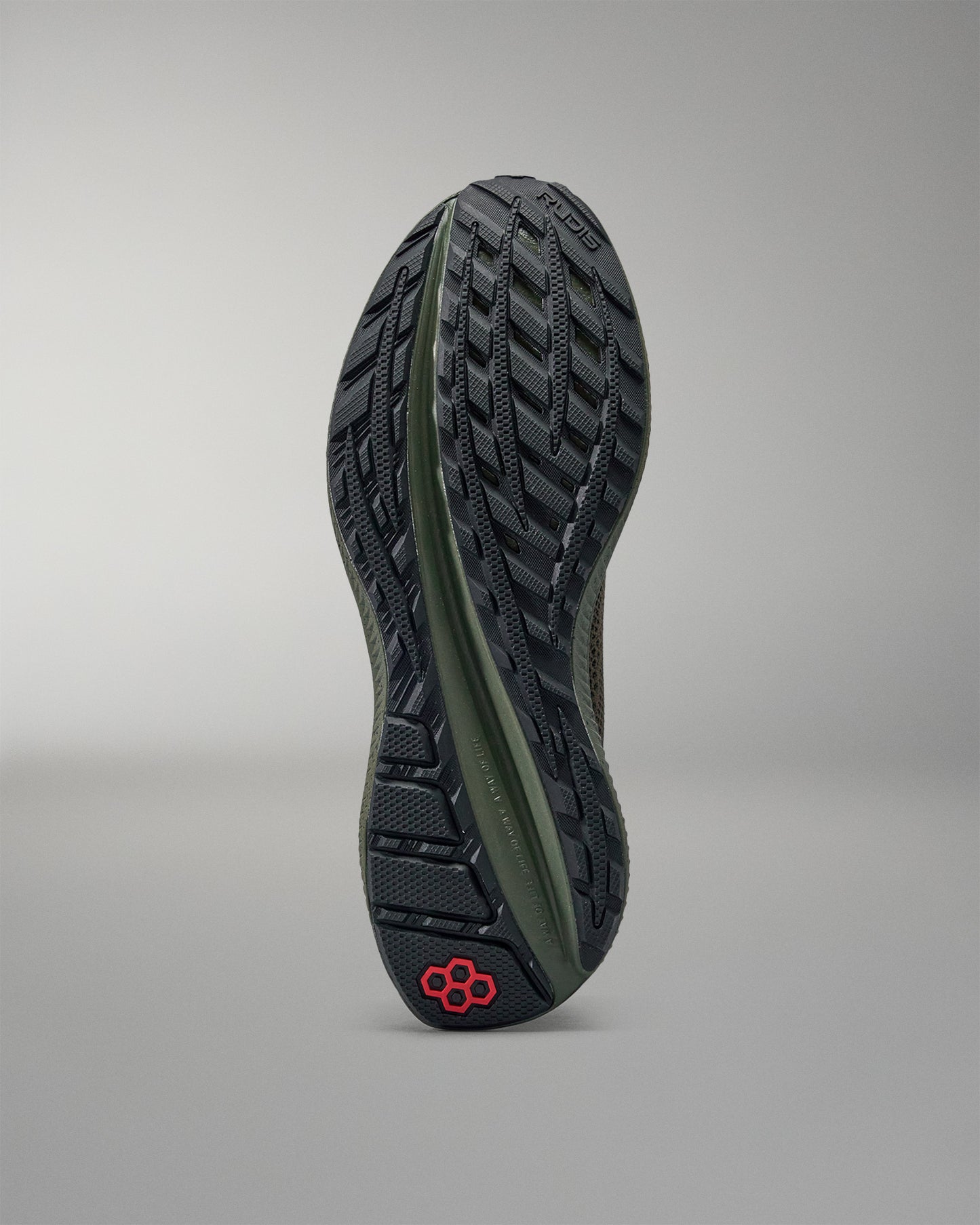 Close-up of a shoe sole with a brand logo on a gray background