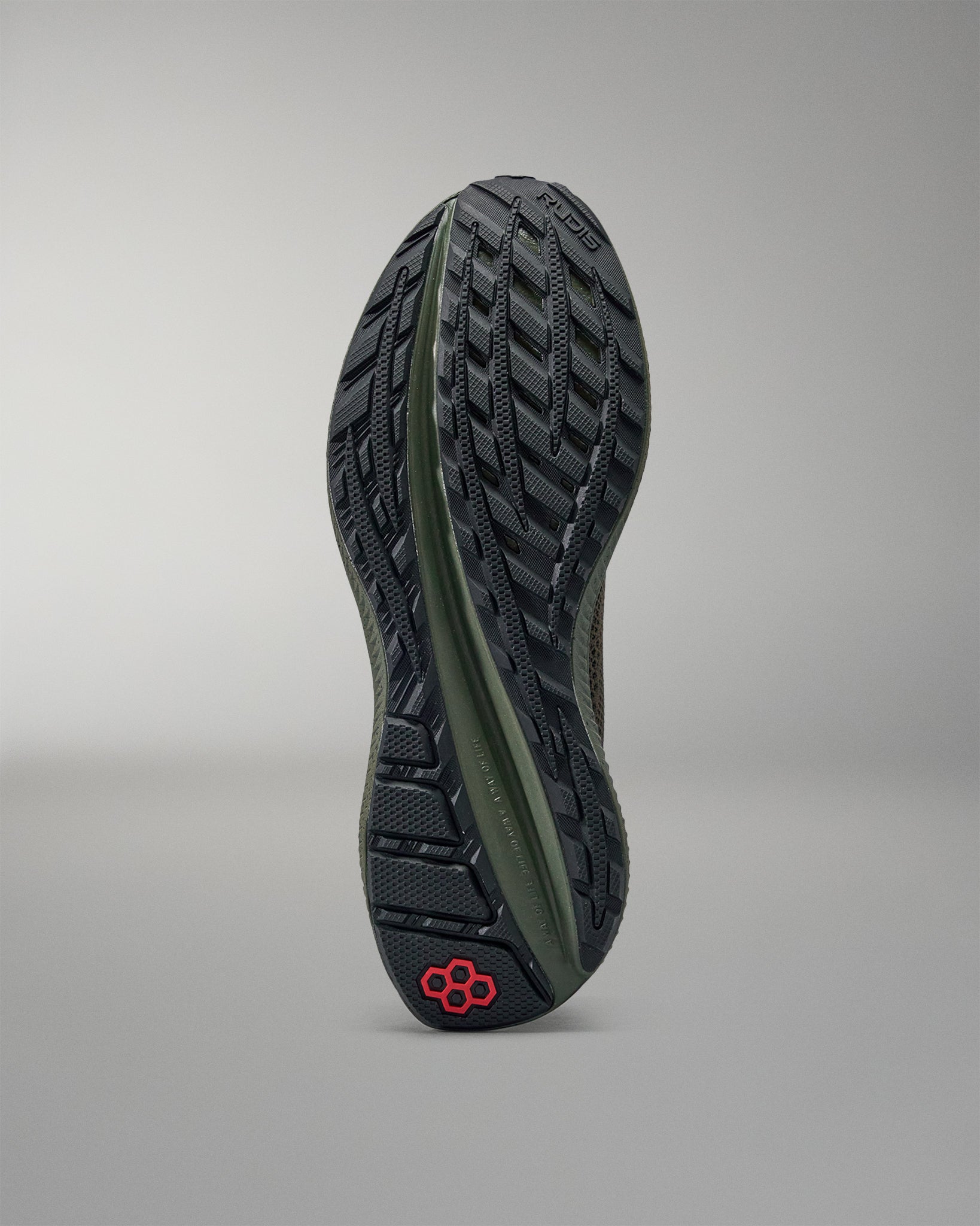 Close-up of a shoe sole with a brand logo on a gray background