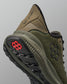 Green training shoe with black sole and red logo on a gray background