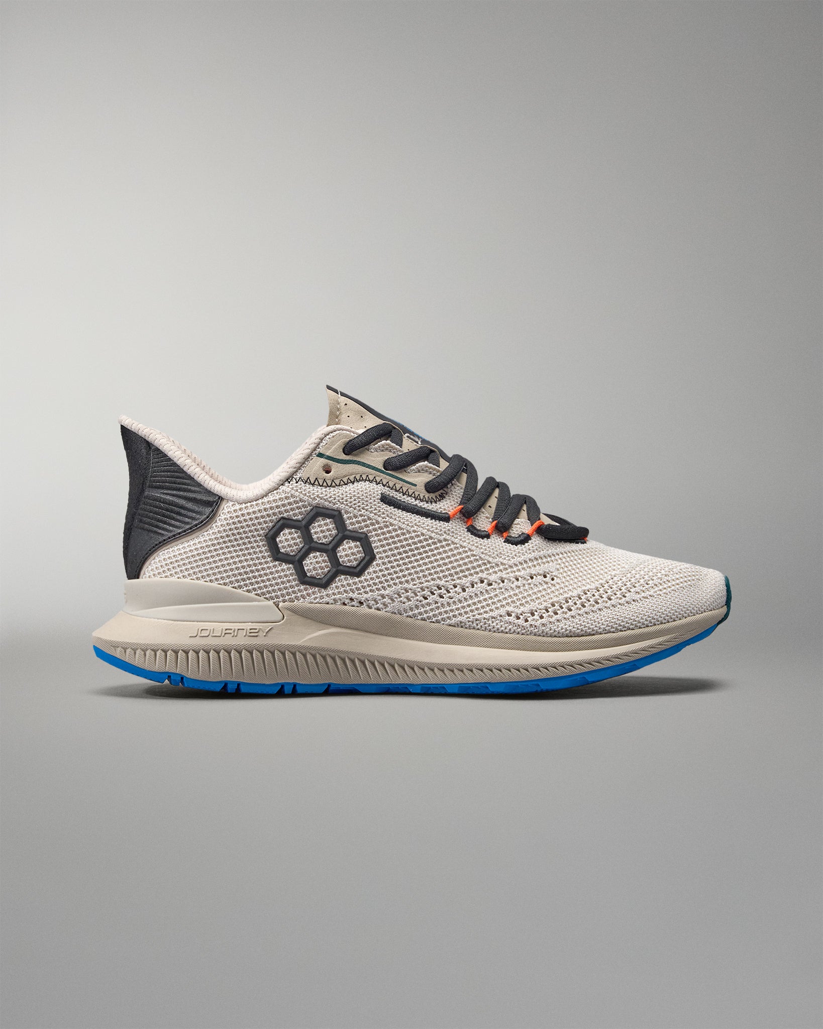 White running shoe with black and blue accents on a gray background