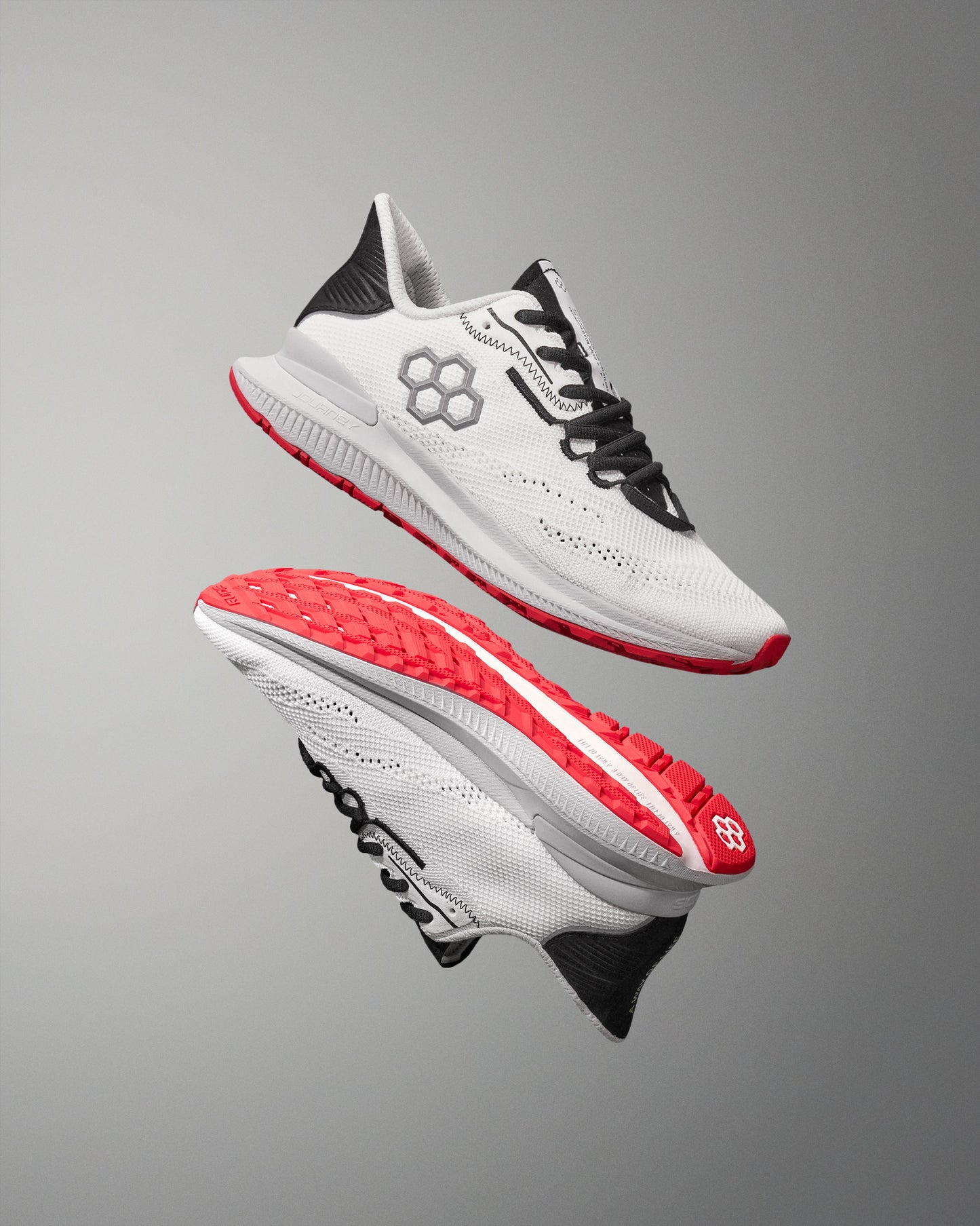 White running shoes with red soles on a gray background